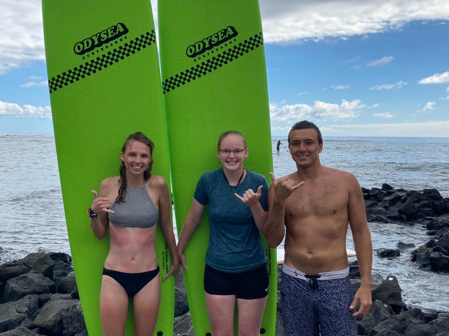 Surf instructor Kaleo with two students